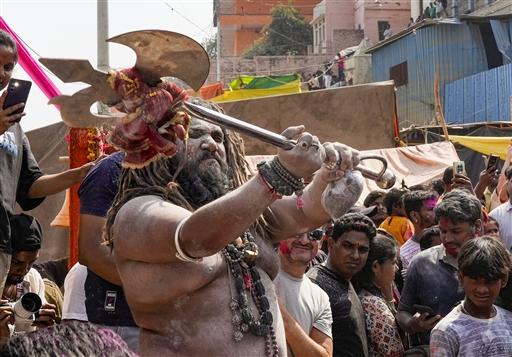 A sadhu joins the Masan Holi celebration with colours and rituals at Harishchandra Ghat, in Varanasi.
