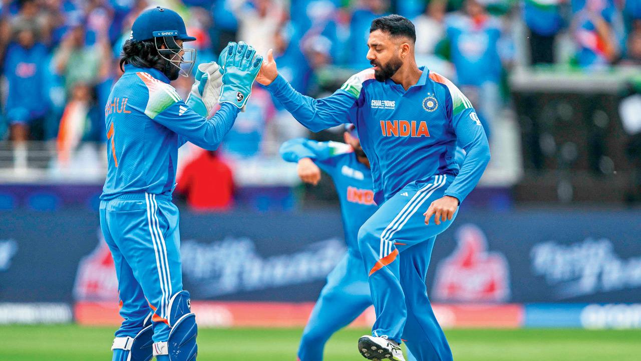 India’s Varun Chakravarthy (right) celebrates with KL Rahul after dismissing New Zealand’s Will Young in Dubai yesterday