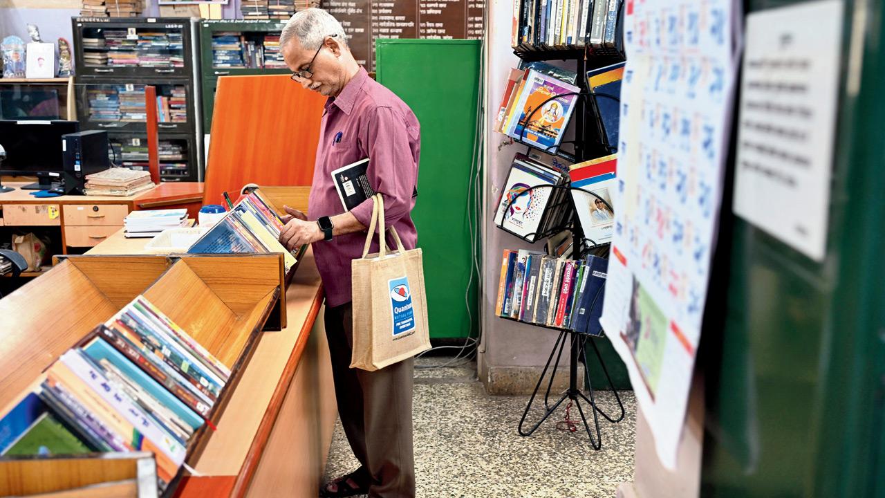 A member checks out recently returned books at the counter