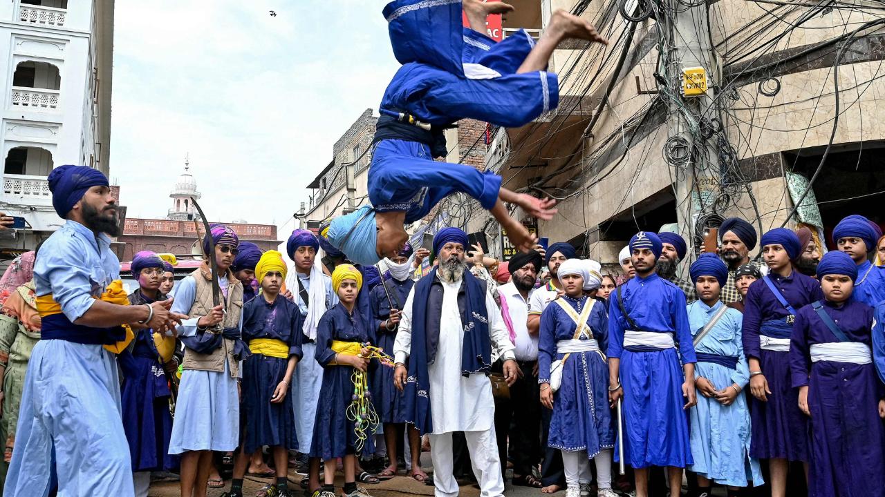 A 'Nihang' or a Sikh warrior performs 'Gatka', an ancient form of Sikh martial arts, during the Hola Mohalla festivities