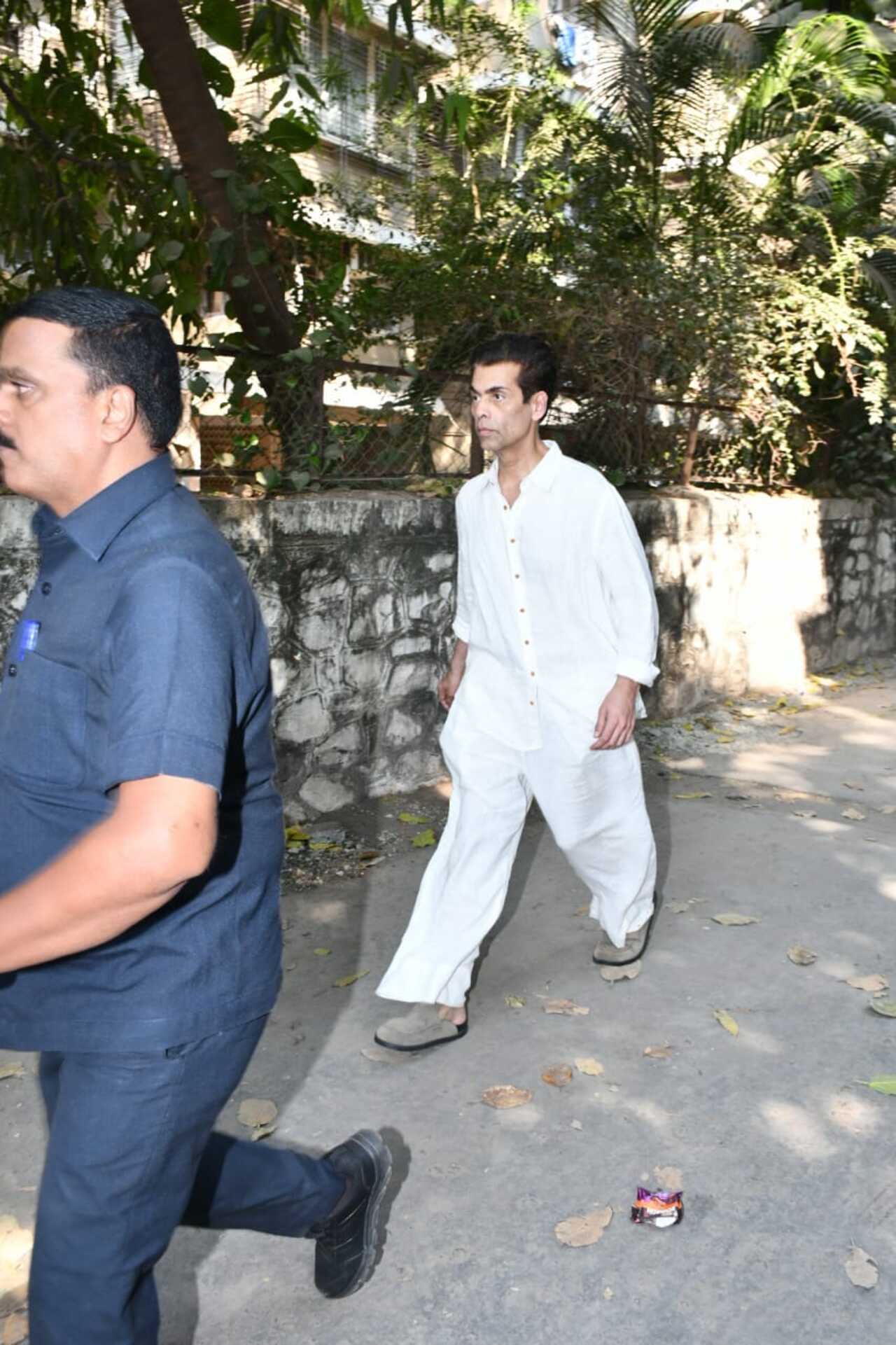 Filmmaker Karan Johar was seen arriving solo for Deb Mukerji's final rites