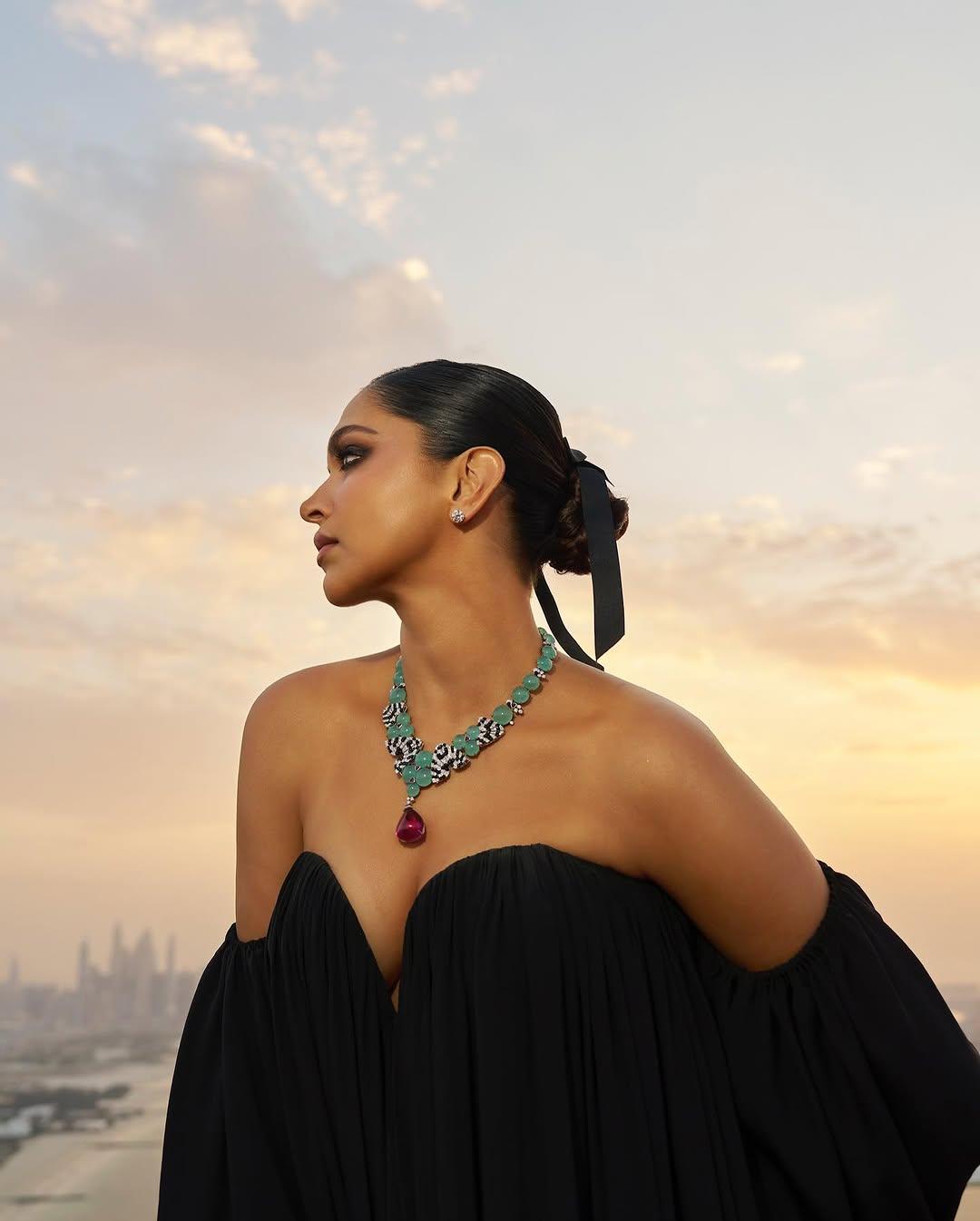 Featuring a plunging sweetheart neckline, voluminous off-the-shoulder sleeves, and delicate ruffles, she completed the look with a sleek twisted bun and a chic black silk bow.