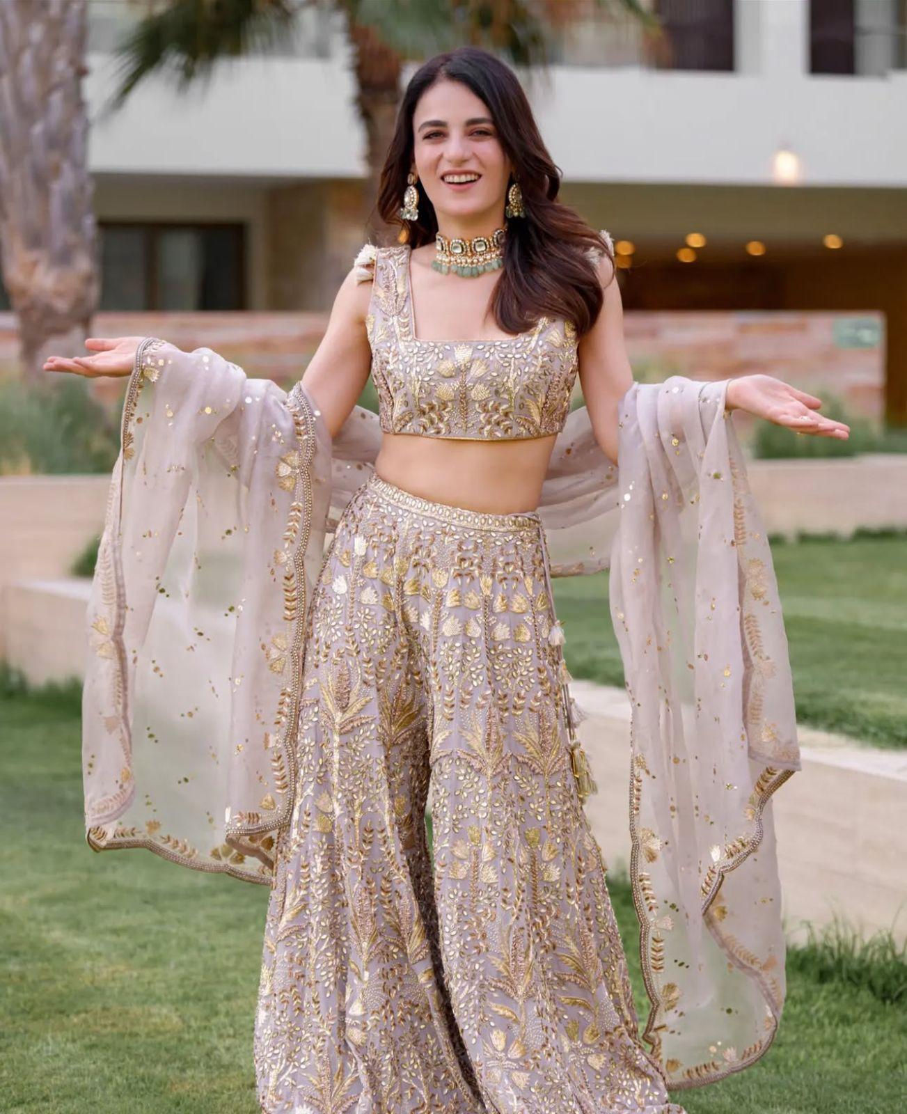  Radhikka Madan channels the Eid ka chand look in an embellished pastel gharara. She layers her outfit with kundan jewellery and enhances her look with dewy makeup
