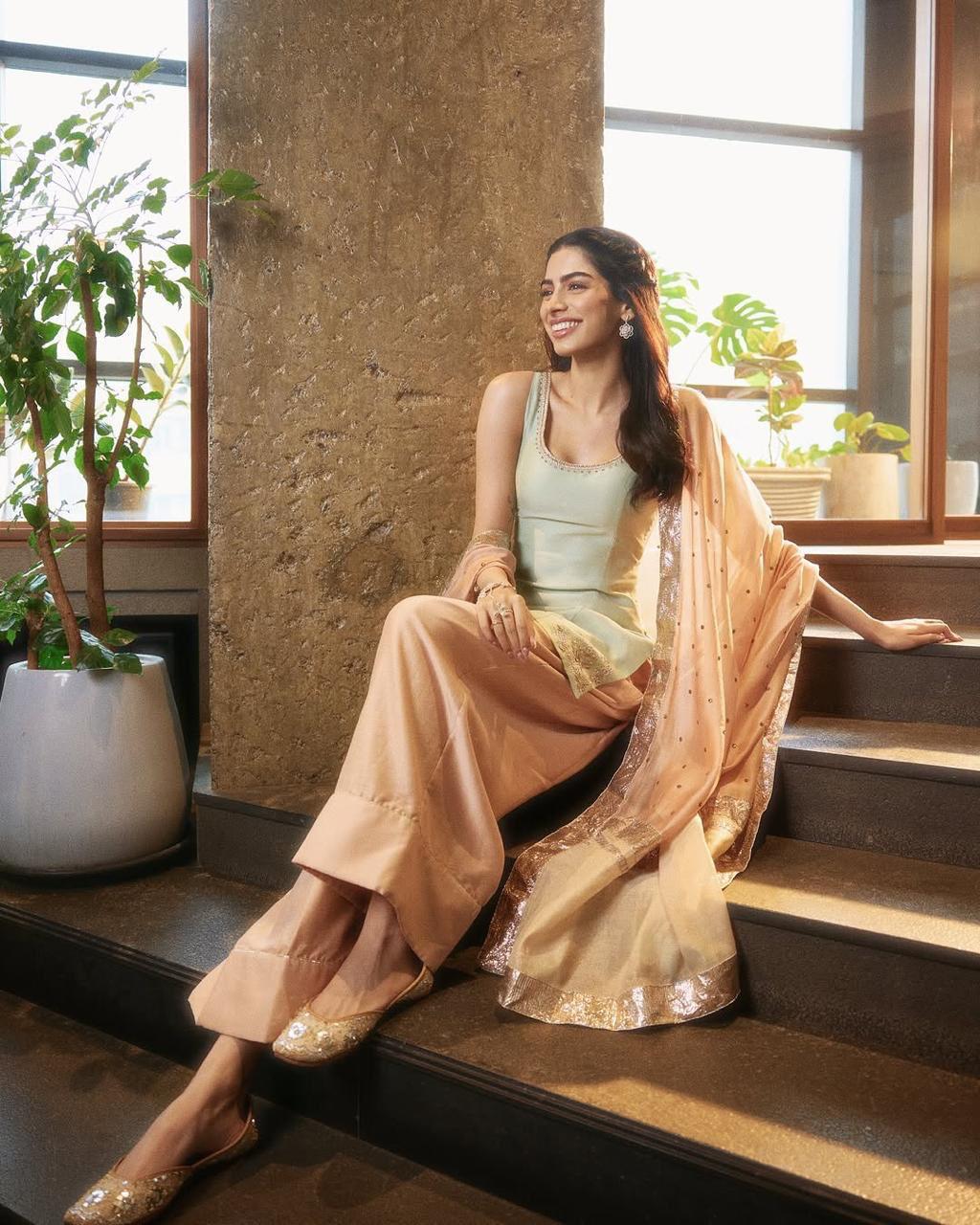 Khushi Kapoor keeps it effortlessly stylish in a pastel peach contemporary kurta set. She completes her look with minimal jewelry and mojaris, exuding an understated charm