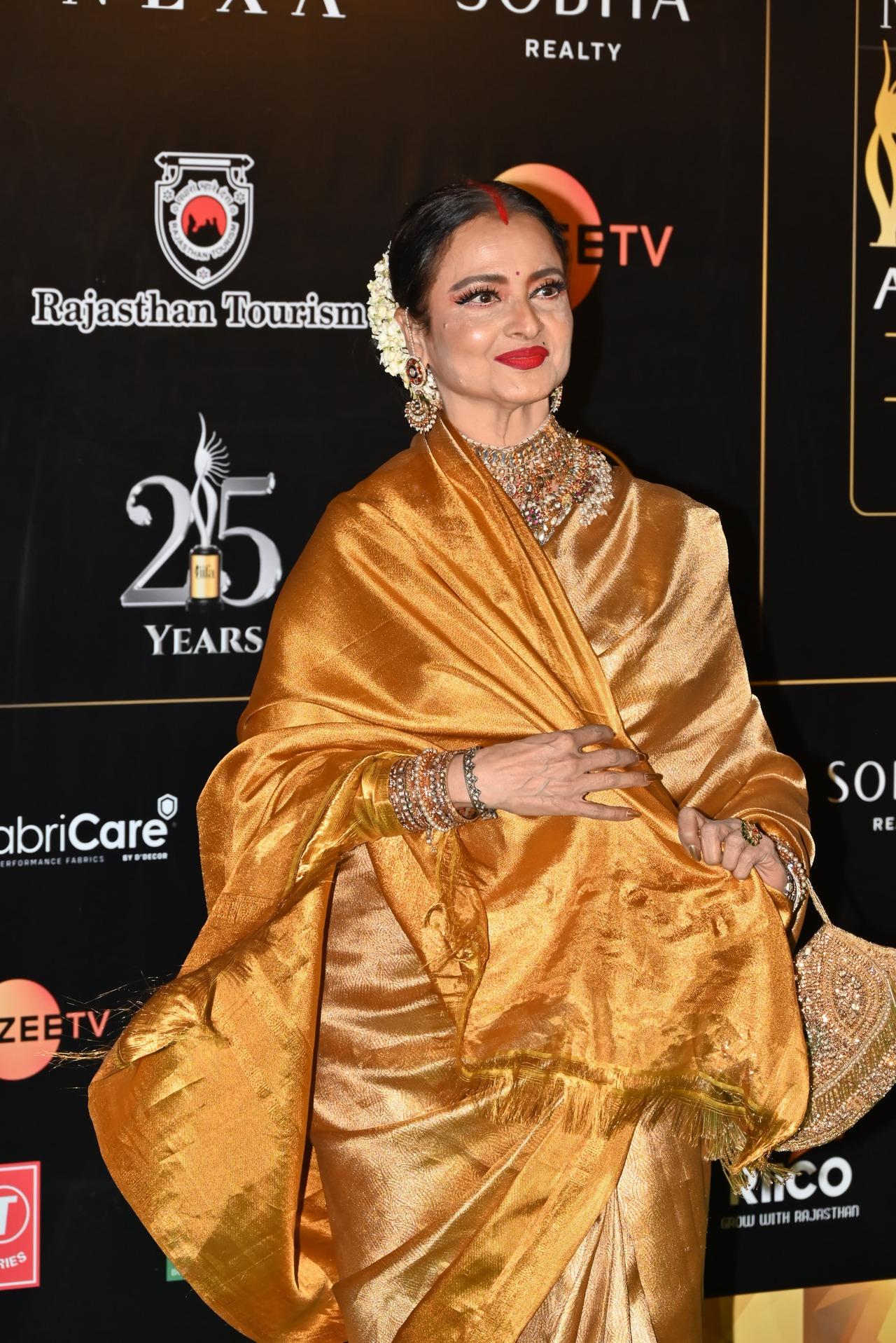 Veteran actor Rekha opted for a mustard yellow saree and loads of jewellery exuding royal vibes.