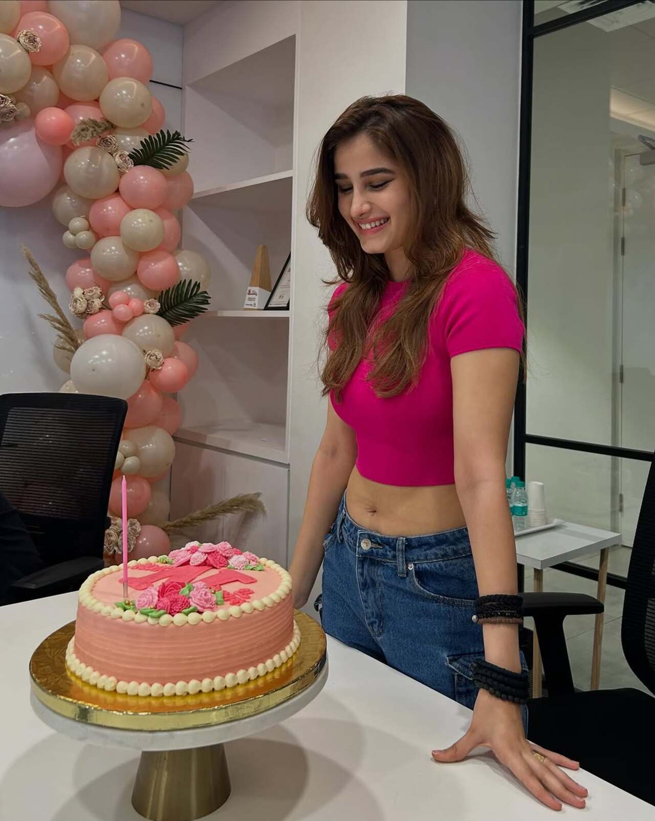 Unlike the black theme of her bash, this one was pink and looked cute, especially with the cake! 