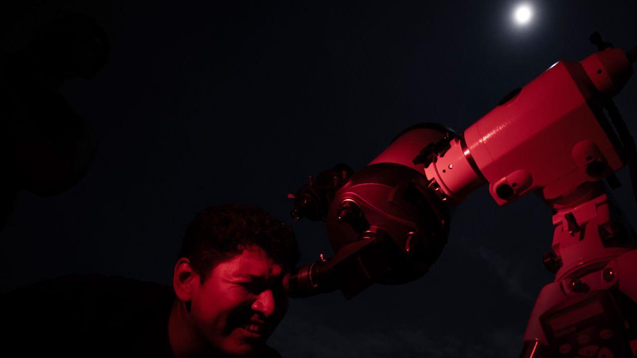 In Belo Horizonte, Brazil, a man took to a telescope to get a closer look at the Blood Moon. The esplanade of the Mineirao stadium offered a stunning vantage point for the lunar eclipse