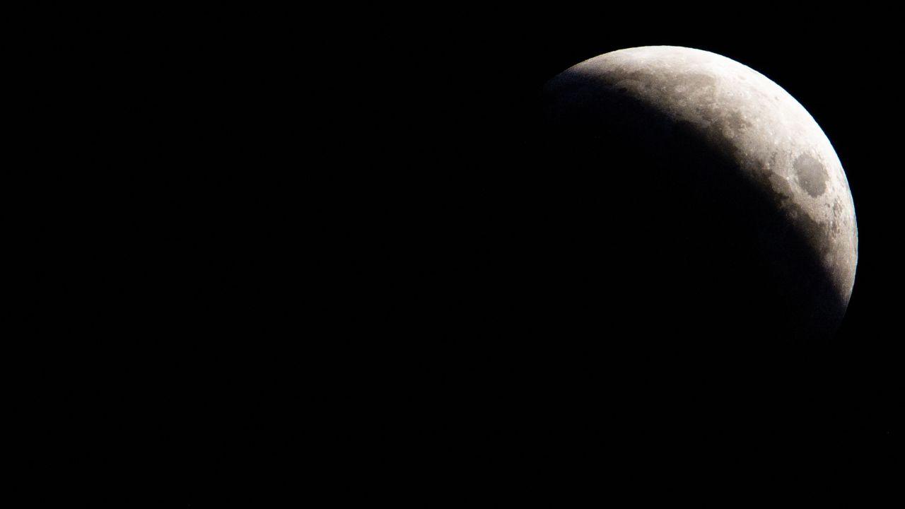 As the total lunar eclipse reached its peak, the moon appeared to glow with the intensity of fiery reds, casting an ethereal light over the landscapes below