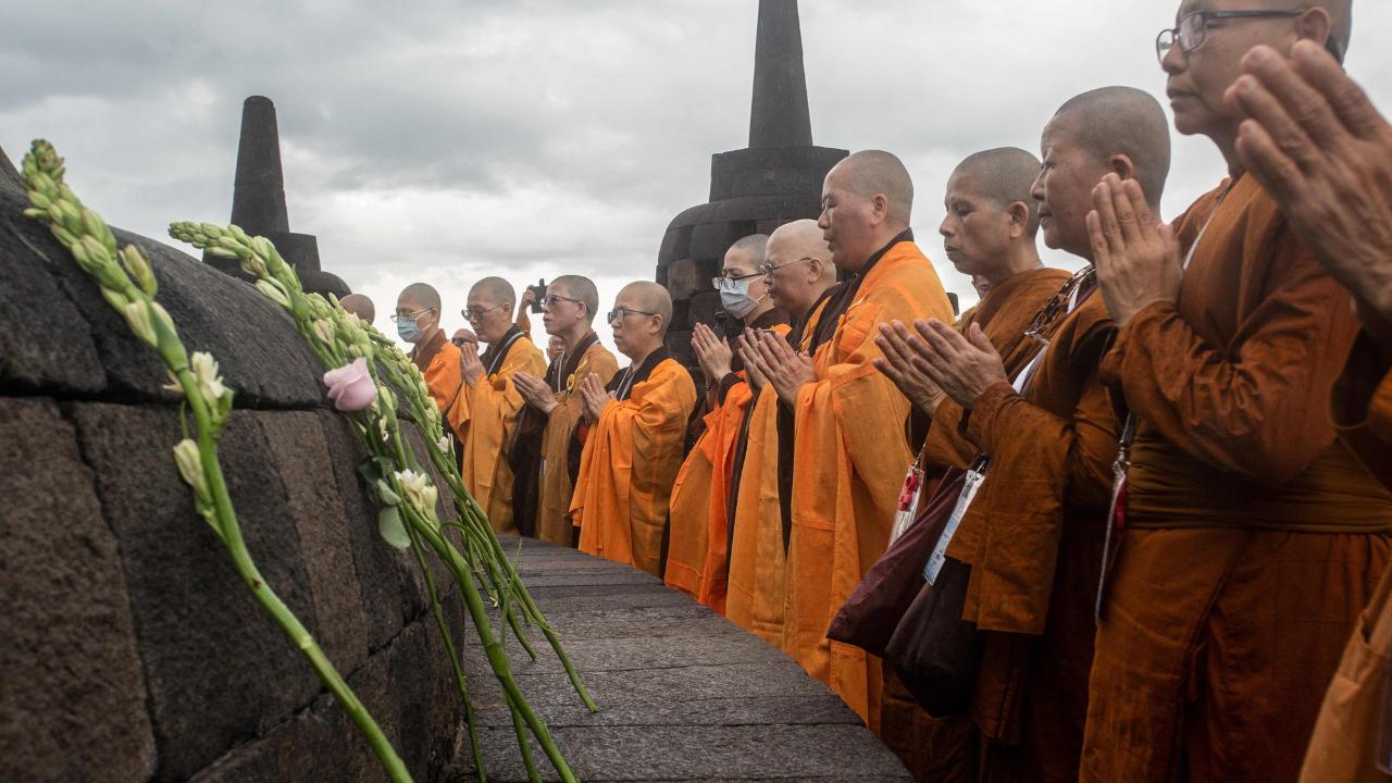 Buddhists walk on petals as they gather from 11 countries to honor International Women’s Day and pray for world peace at the Temple on March 7, 2025
