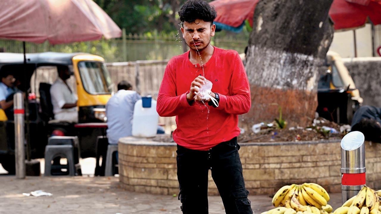 A fruit vendor squeezes a water pouch on his face. Pic/Anurag Ahire