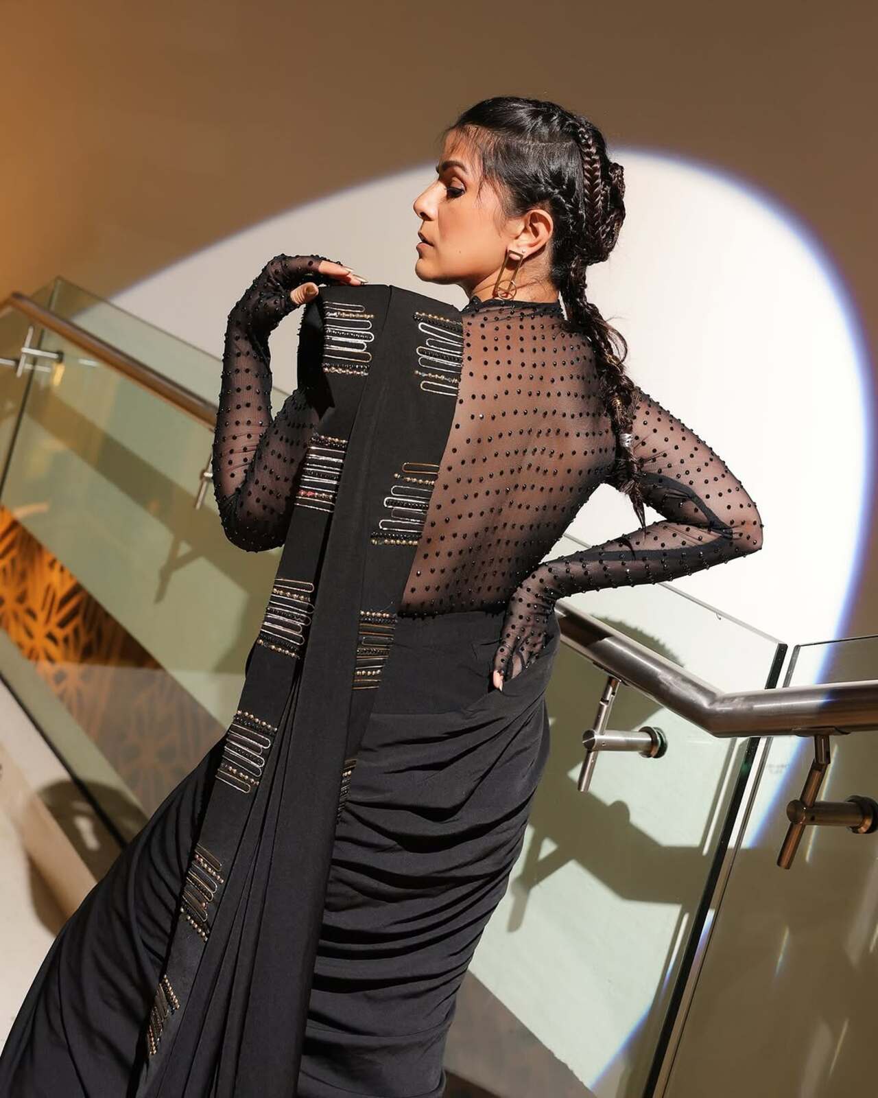 She tied her hair up in plaits with small strands of hair framing her upper face. She also opted for geometric gold plated accessiores to complete the look