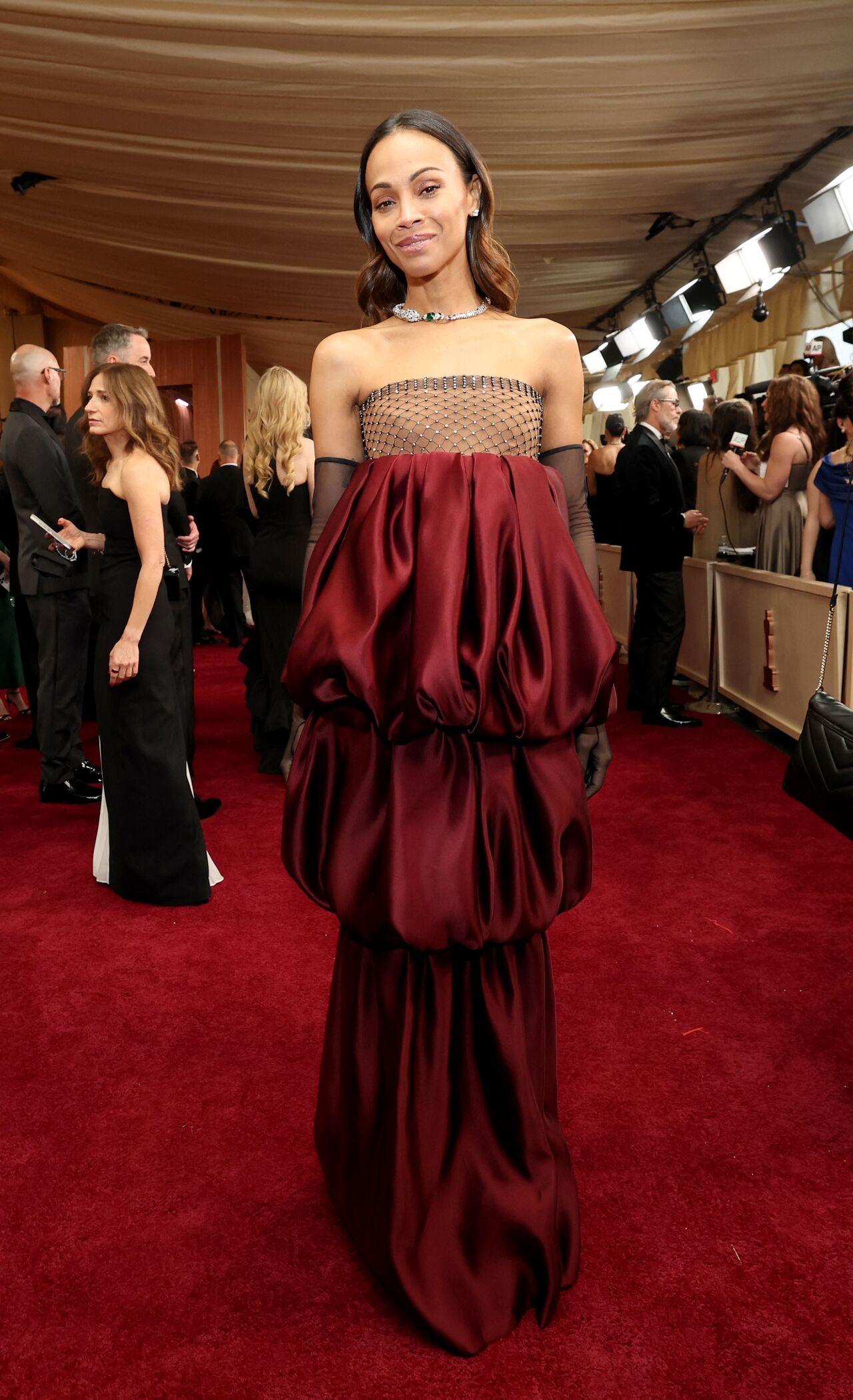 Emilia Perez actor Zoe Saldana chose a deep burgundy strapless tiered look by Saint Laurent.
