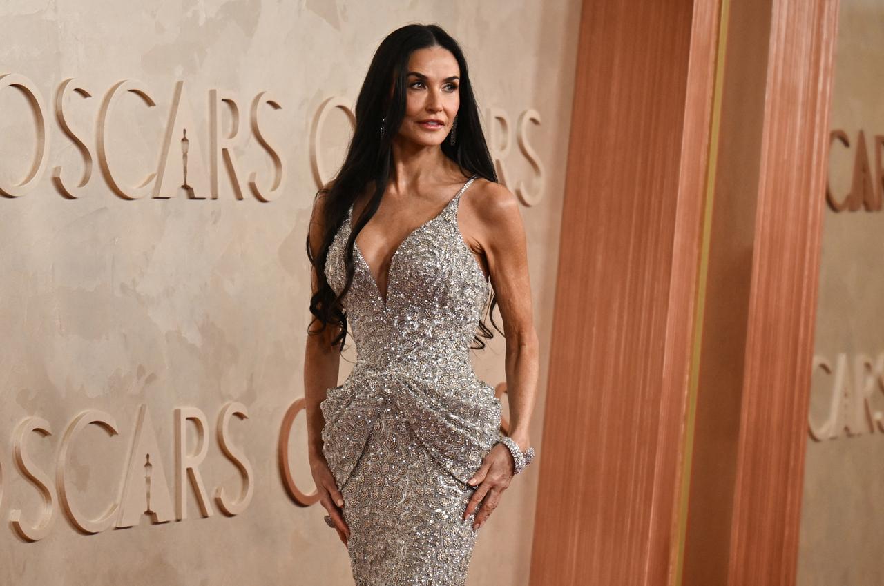 Demi Moore looked radiant in a custom Giorgio Armani Prive crystal-embroidered gown. The 62-year-old actress added some extra sparkle with matching earrings and a bracelet, and her long, dark hair cascaded into soft curls.