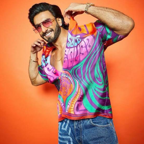 Ranveer Singh’s rainbow-colored shirt is the perfect Holi choice—bright, flamboyant, and full of life. Known for his love of loud prints, he embraces vibrant fashion effortlessly.