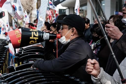 Protests have intensified since Yoon’s impeachment in December, with his supporters growing increasingly aggressive after his arrest in mid-January and subsequent indictment on insurrection charges. Outside a detention centre on the outskirts of Seoul, Yoon’s supporters gathered in prayer circles, holding South Korean and American flags and banners with the phrase 