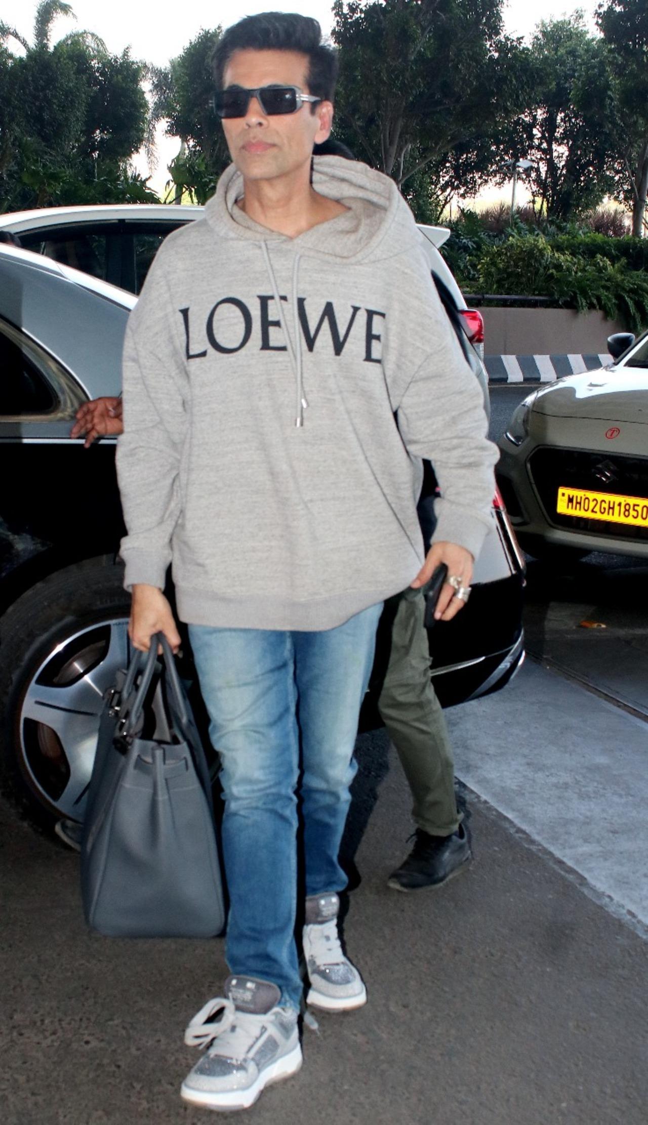 Karan Johar was spotted in an oversized grey hoodie and denim pants at the Mumbai airport. He was headed to Jaipur airport for the IIFA awards