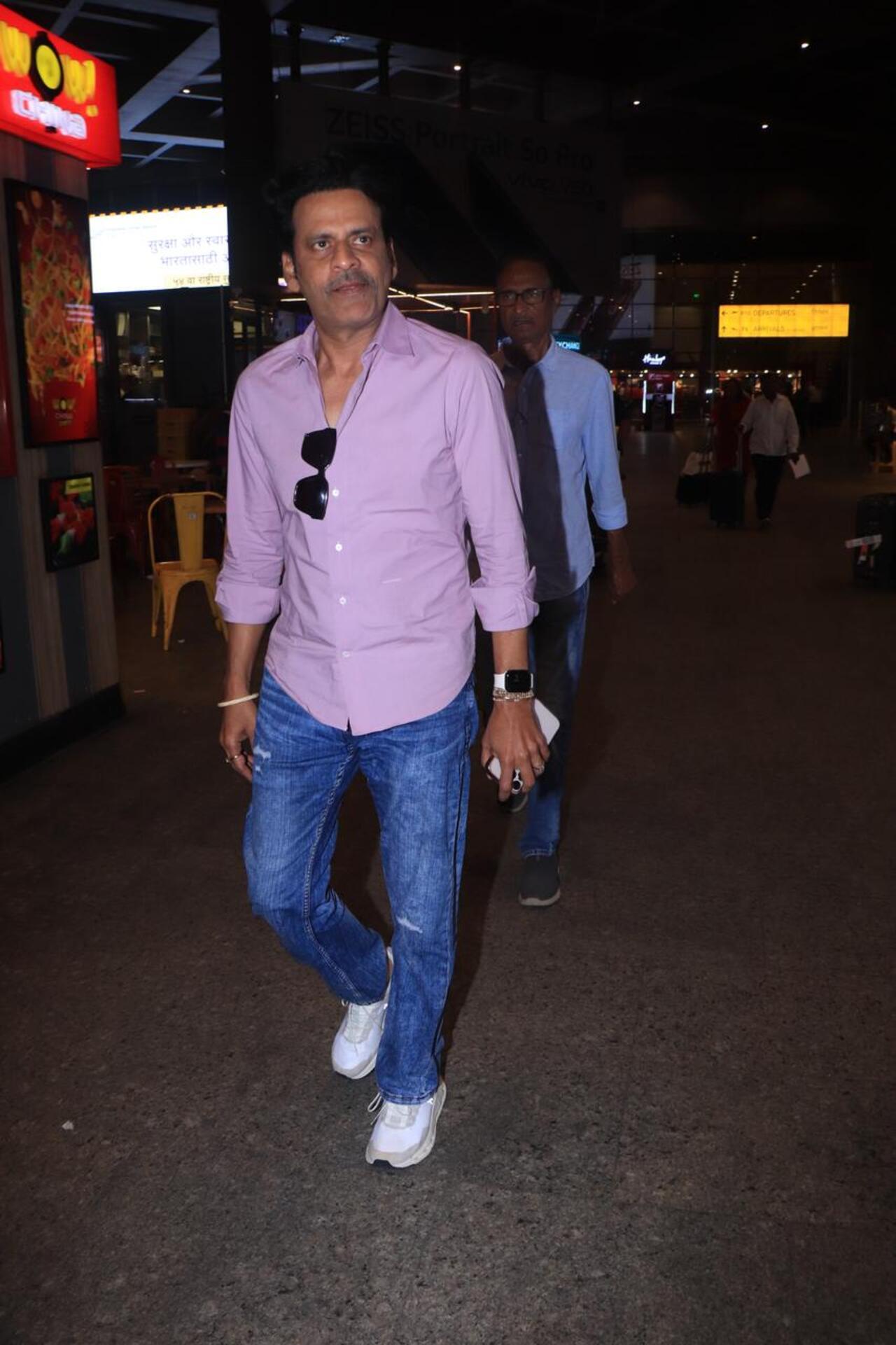 Actor Manoj Bajpayee was seen in a purple shirt and denim pants, sporting a thin moustache while he got papped at the airport