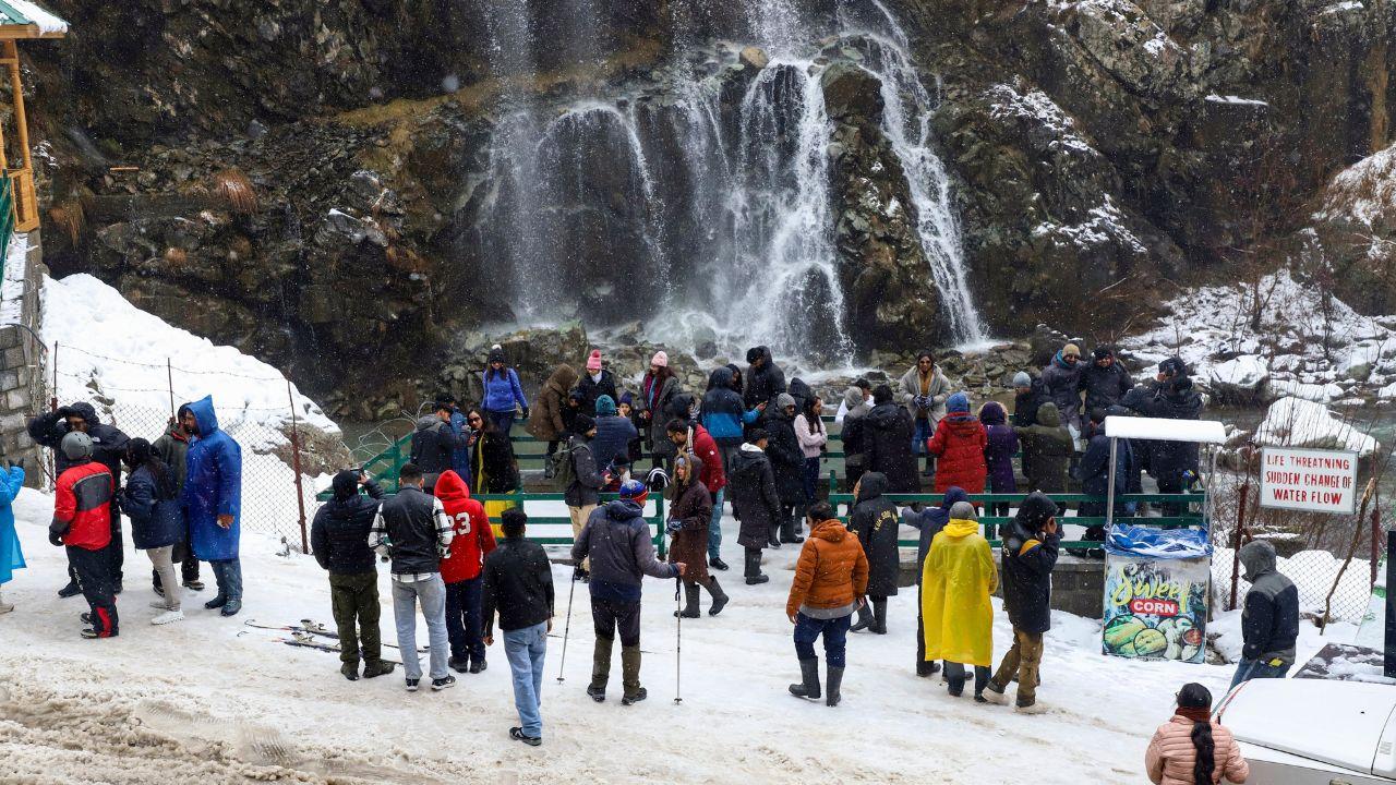 After fresh snowfall in Tangmarg, tourists and locals flock to the waterfall at Drung