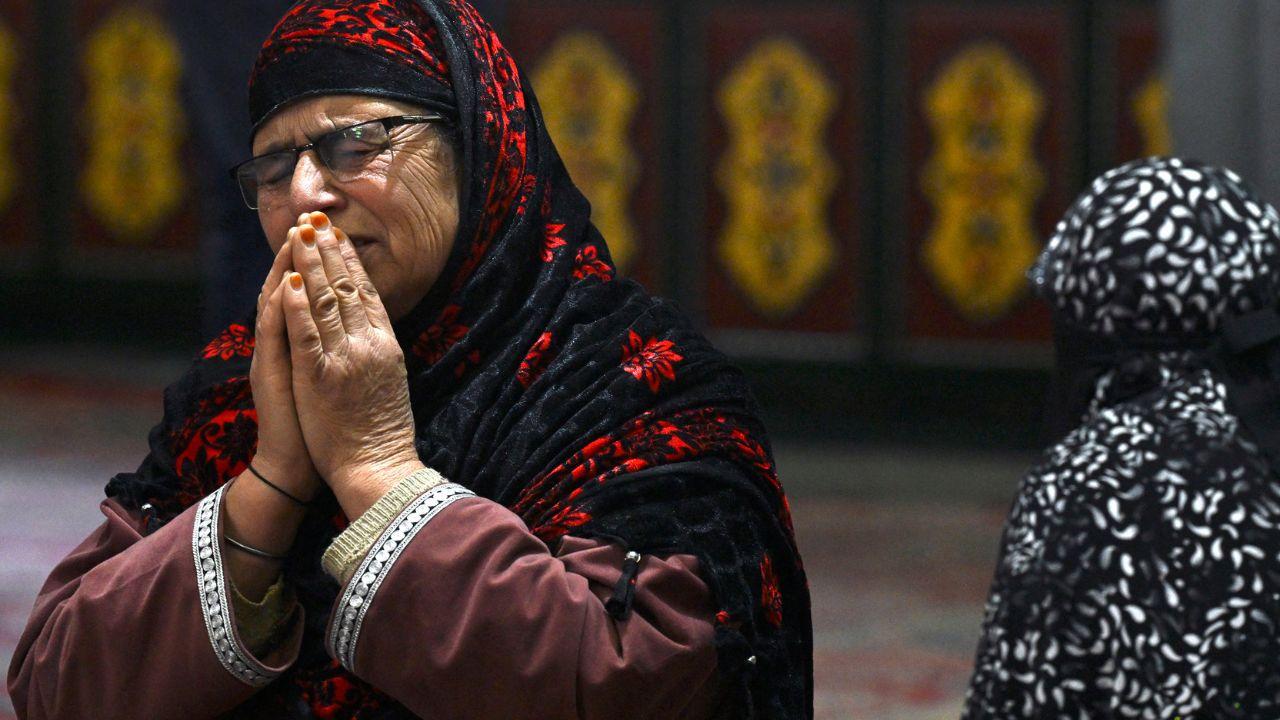 A woman prays at the Sheikh Syed Abdul Qadir Jeelani shrine in Srinagar