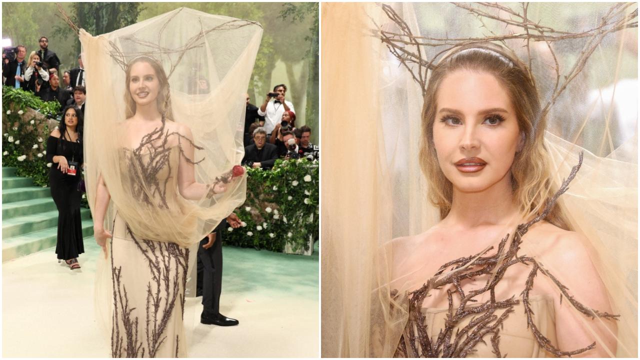 Lana Del Rey – 2024
Lana Del Rey, who made her comeback at Met Gala after five years in 2024, personified the dress code ‘Garden of Time’ as she showed up dressed as a literal tree! She opted for an Alexander McQueen gown, which was adorned with twigs. However, the highlight of the look was the headgear made of real branches and covered with a dramatic veil. This dreamy outfit was the right kind of bizarre and stole the spotlight at the event
