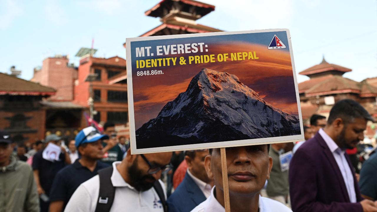 To celebrate the day, locals and mountaineers held a procession during which participants held flags and banners with names and achievements of people who dared to climb Mount Everest. Some banners also featured slogans like ‘Mount Everest: Identity & Pride of Nepal’