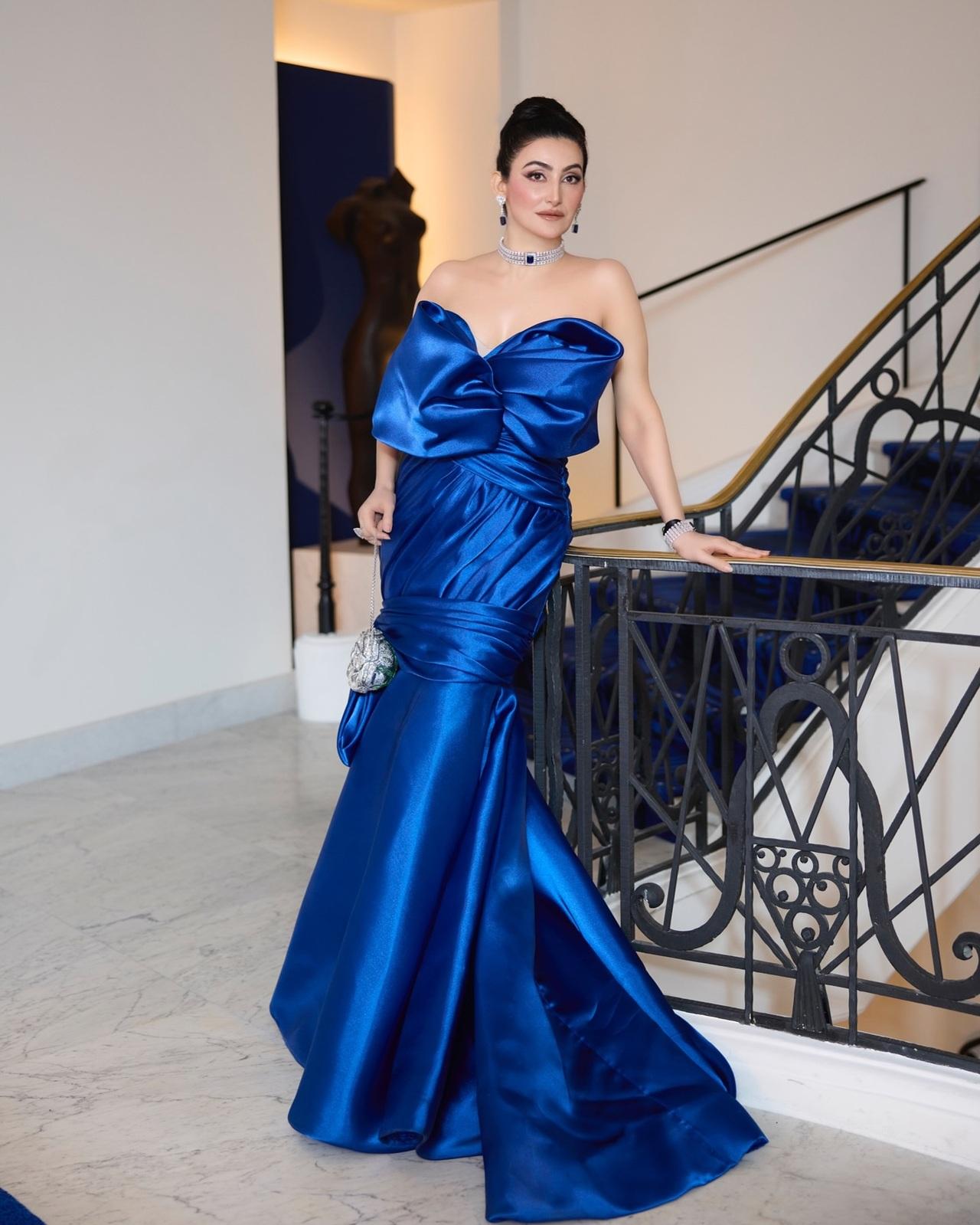 She dazzled in this midnight couture at a soiree hosted by Caroline Scheufele at Cannes-Mandelieu Airport, where 'cinema, couture, and constellations aligned'. She paired the look with a silver rose Judith Leiber bag, but it was the Chopard diamonds that truly stole the show, radiating elegance and opulence