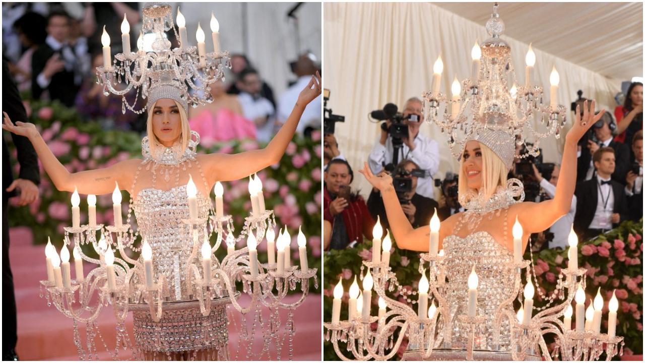 Katy Perry – 2019
Talking about bizarre, Katy Perry showed up dressed as a crystal chandelier at Met Gala 2019. The custom Moschimo outfit featured working lights on the head and around the waist. But one dramatic look wasn’t enough! The singer donned a cheeseburger outfit at Met Gala 2019 after-party, making it one of the most bizarre looks at the event
