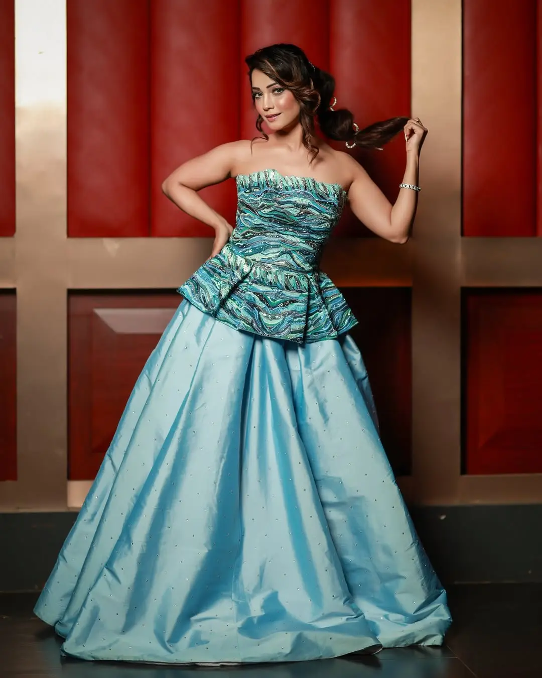 Here, the actress wore a grand blue long skirt and paired it with a strapless blue top featuring multiple patterns, giving off a perfect princess vibe