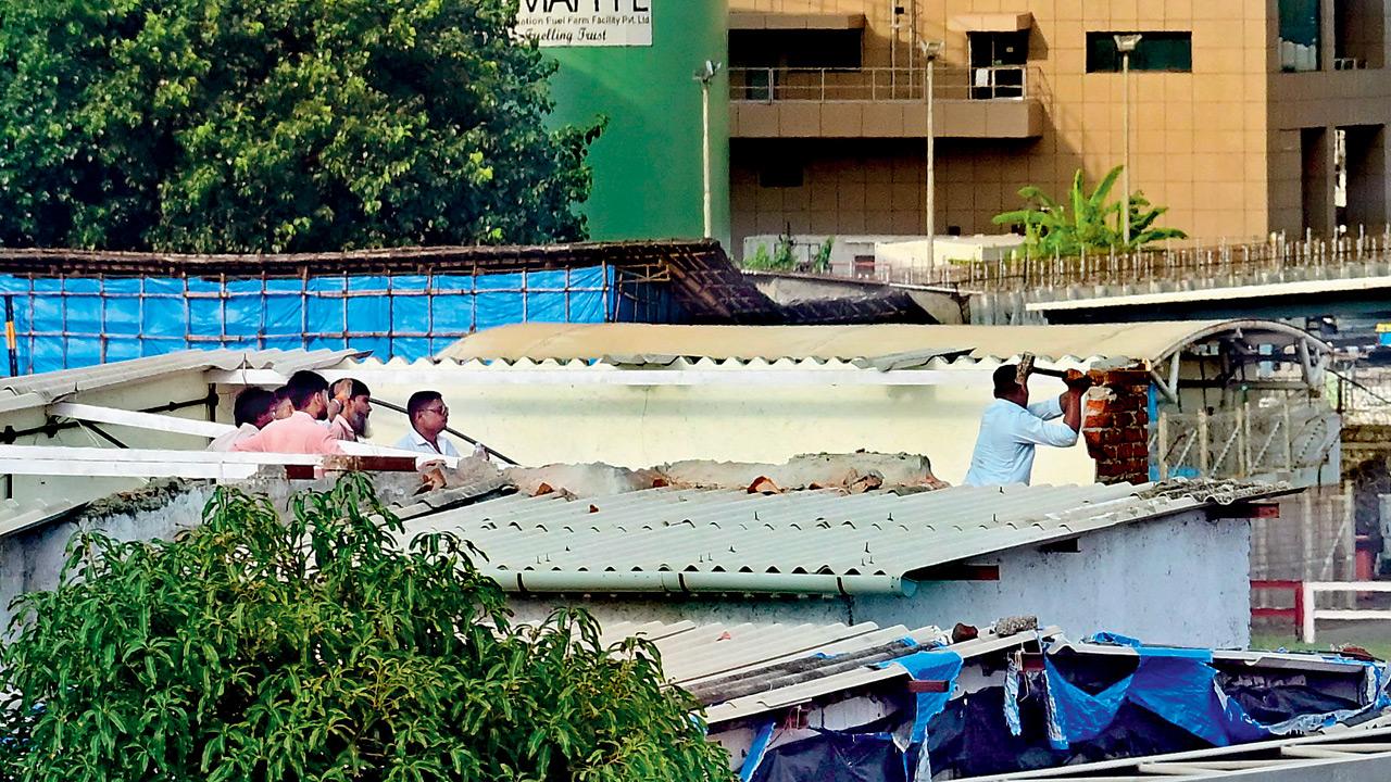 Structures alongside the runway of T2, which are a part of the funnel zone, were demolished at Santacruz on Wednesday. Pic/Nimesh Dave