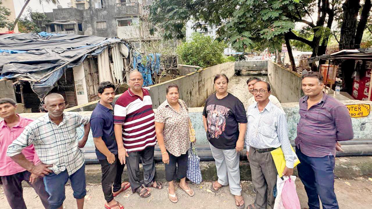 Andheri residents strike a pose near the nullah after it was desilted on May 29. Pics/By Special Arrangement