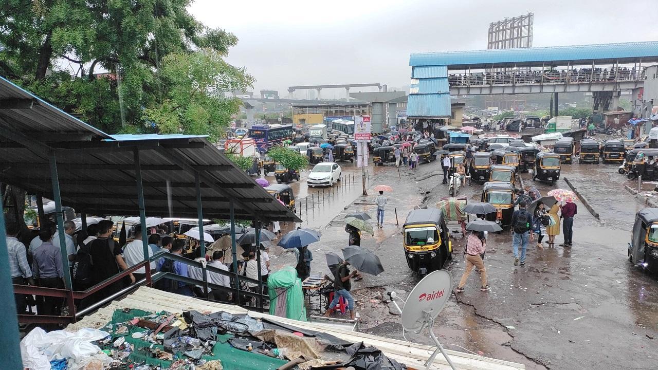 PICS: Office-goers brave rain outside Bandra station to find public transport
