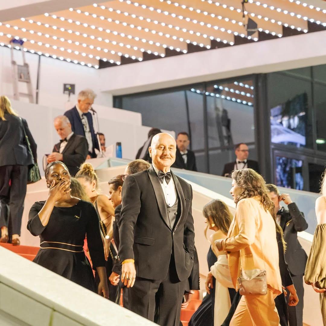 Anupam Kher looked smart in a two-piece suit. The actor paired it with a crisp white shirt and a black bow tie. He was seen posing for the cameras on the red carpet