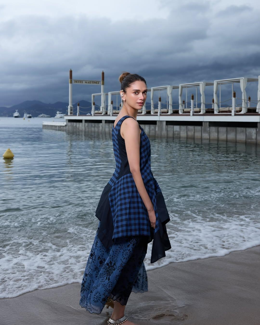 She wore a stylish blue ensemble featuring a mix of checkered and floral patterns, her hair tied up in a neat bun. Even amid overcast skies, Aditi Rao Hydari brought her signature charm and elegance to every frame