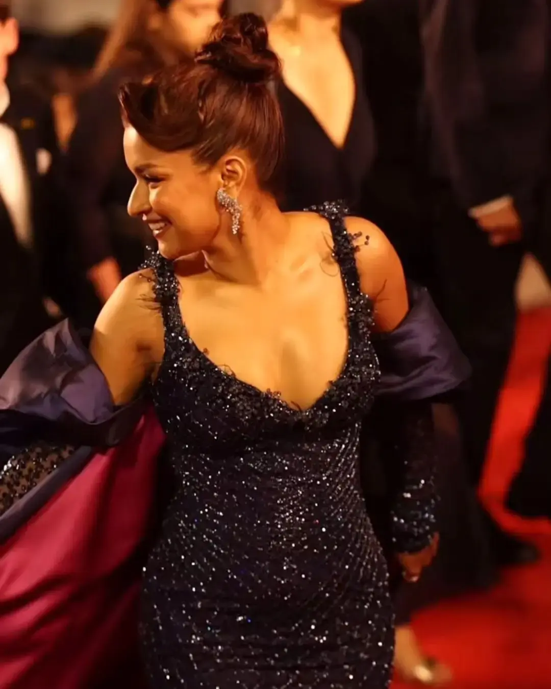 Avneet Kaur made a dazzling red carpet appearance in a deep blue outfit that featured a glittering bodice and a dramatic train extending from her sleeves. Her look was styled with diamond-studded gladiator heels and statement earrings, adding a bold, modern twist to the glamorous ensemble