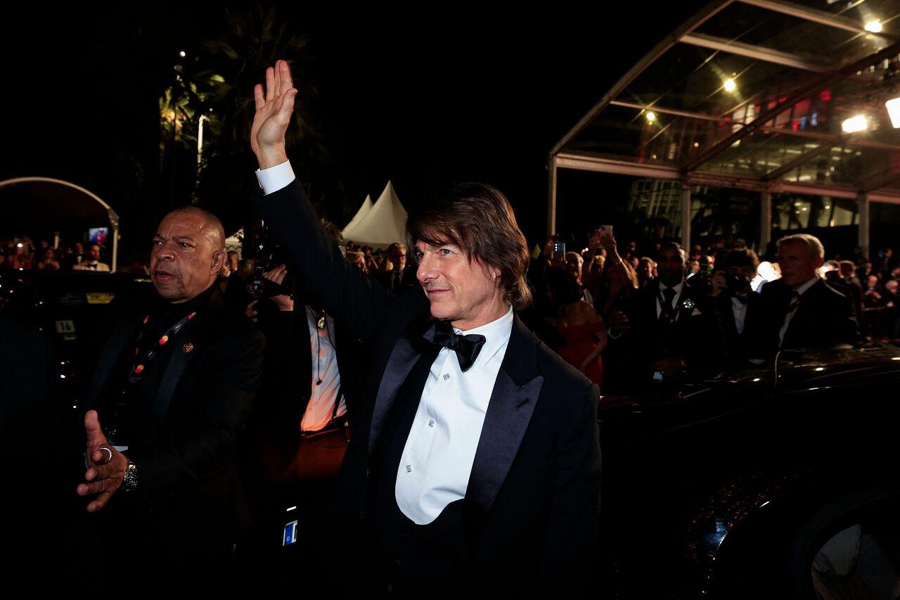 Tom Cruise left hearts racing as he waved at the crowds, looking handsome in a black suit paired with a white shirt and a bow tie. This picture was taken after the screening of his film as he was preparing to leave the venue