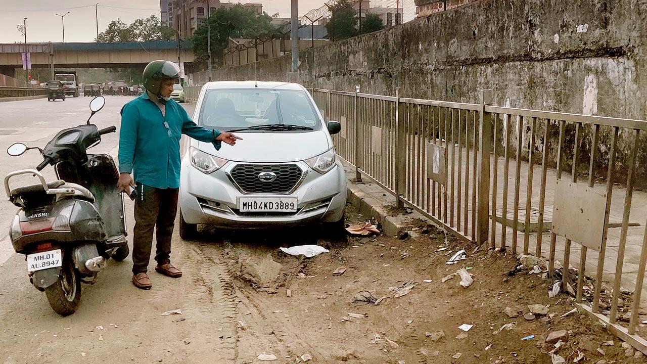 Nafees Ansari points to the dried-up silt lying on the road
