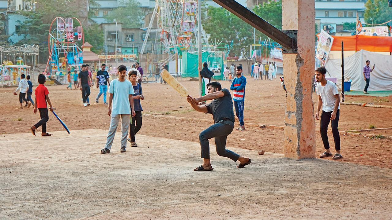 Children forced to play on a small protion of the ground as the unauthorised fair continues in the background on Thursday