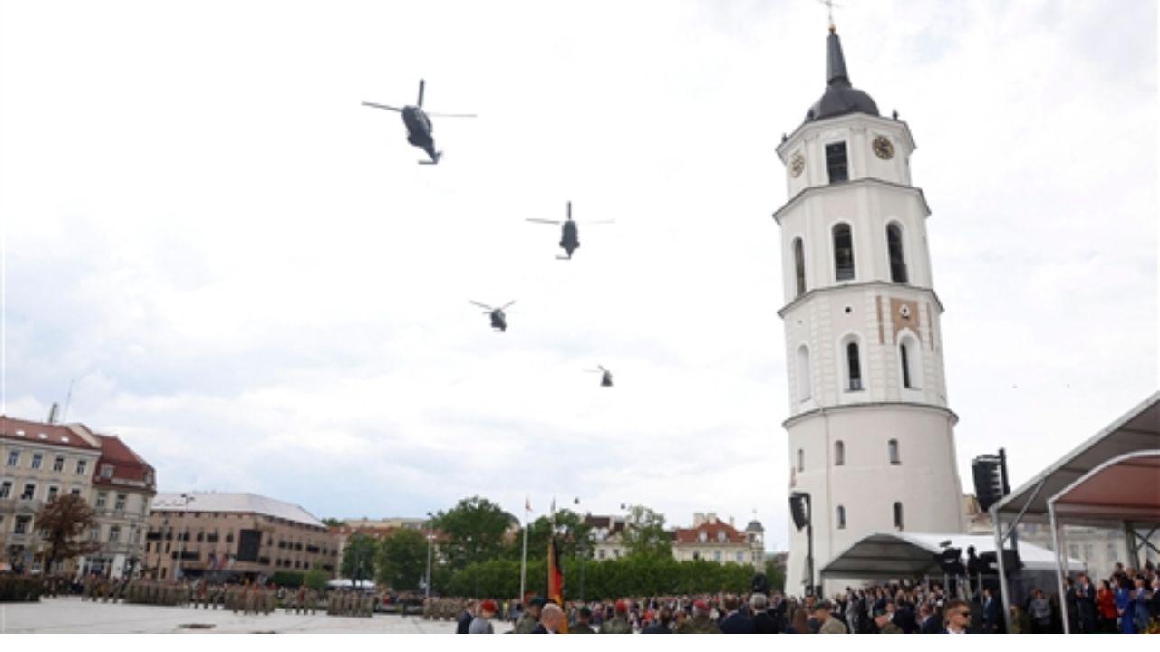 Helicopters fly over the Cathedral Square during the line-up roll call ceremony for 45th Armoured Brigade at in Vilnius, Lithuania