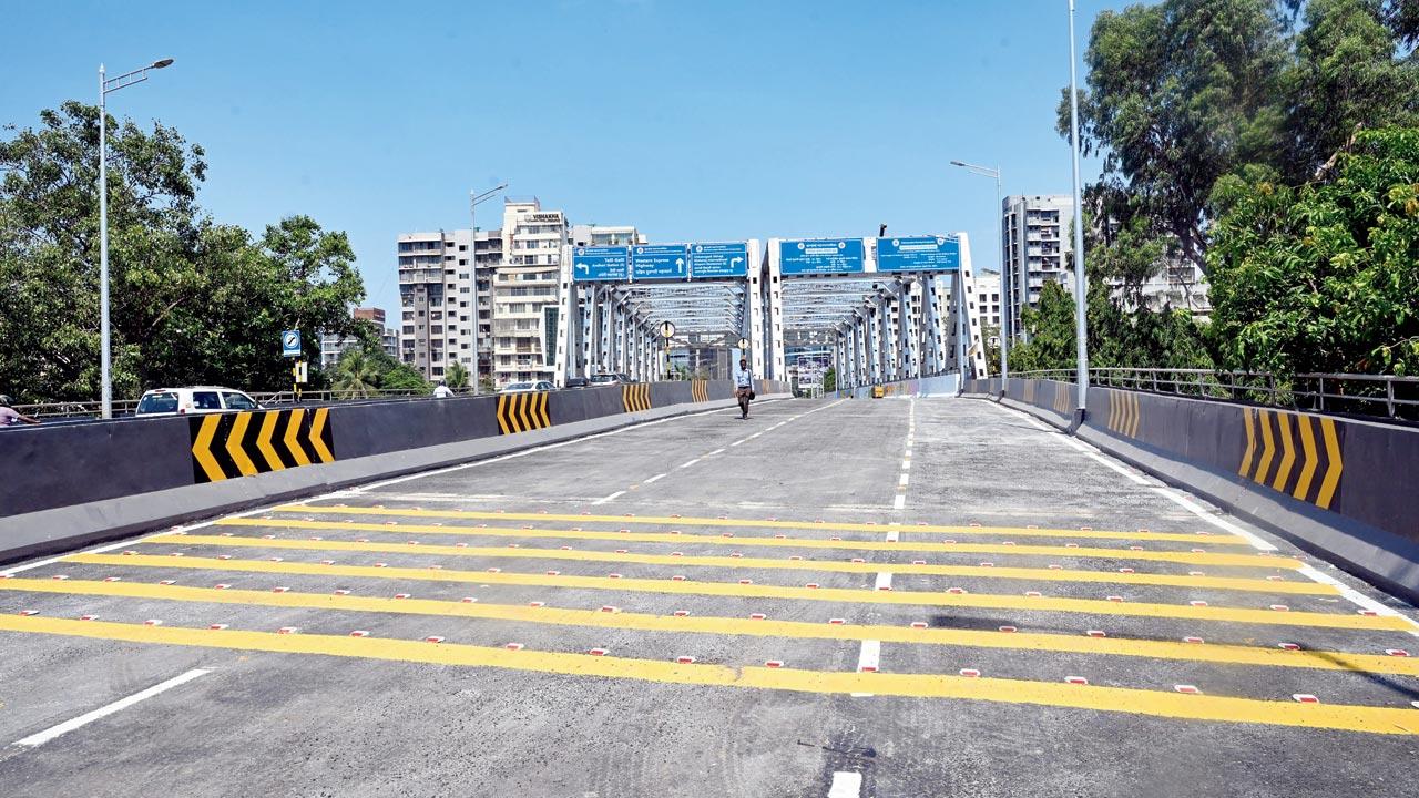 Gokhale Bridge awaits its opening, as finishing touches are put by workers and by artists from the NGO Project Mumbai. Pics/Satej Shinde