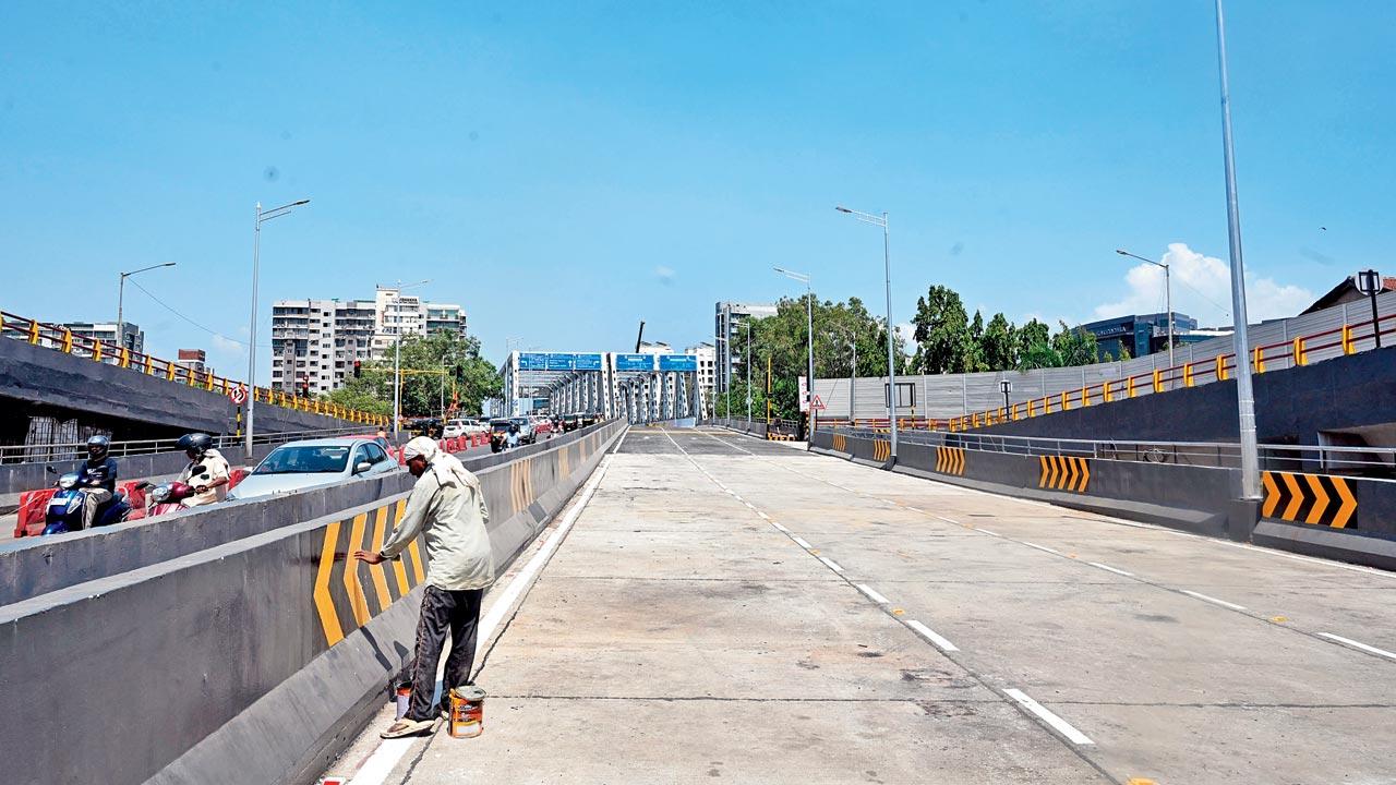 Gokhale Bridge awaits its opening, as finishing touches are put by workers and by artists from the NGO Project Mumbai. Pics/Satej Shinde