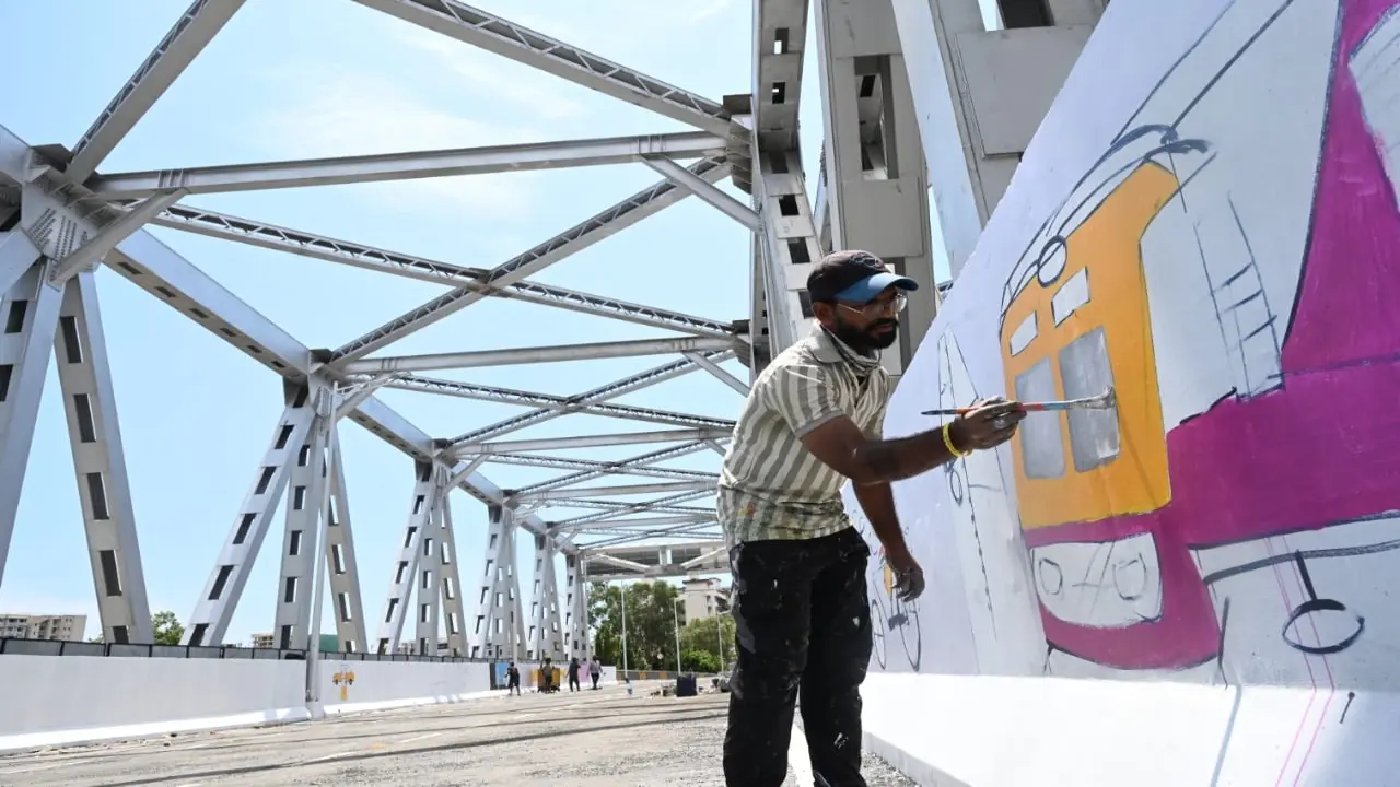 The murals were painted on the grid section of the bridge above the railway tracks 