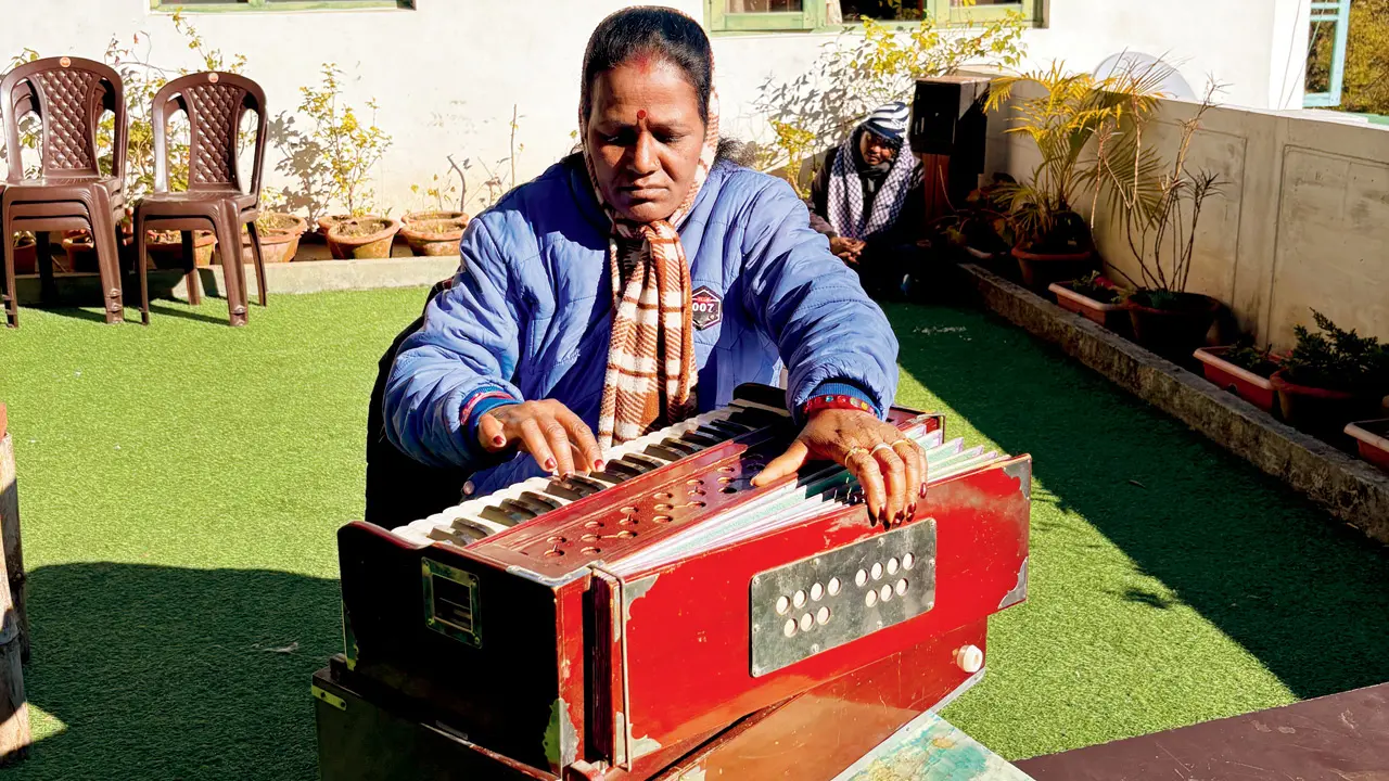Hemanti Devi practises on a harmonuim