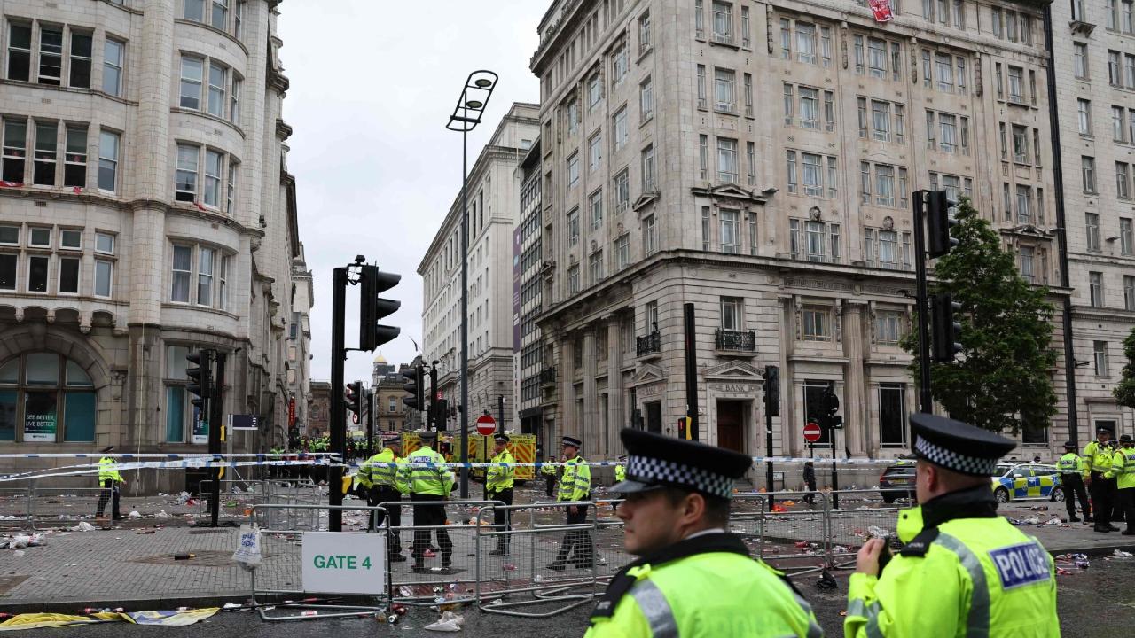 Water Street, near the River Mersey in the heart of the city, was cordoned off by police tape, and a blue tent had been erected on the road strewn with the detritus of celebration, including bottles, cans and Liverpool flags