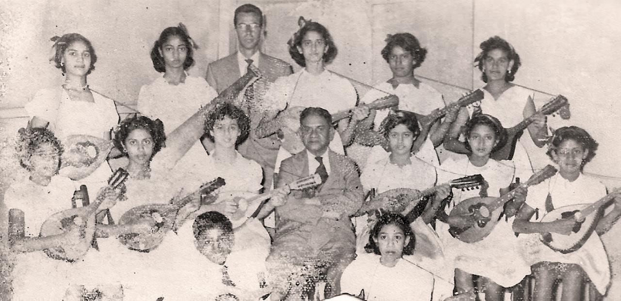 The Melita Plectrum Orchestra. Dagmar Lopes (second from left, top row) is seen holding the saw-derived musical instrument 