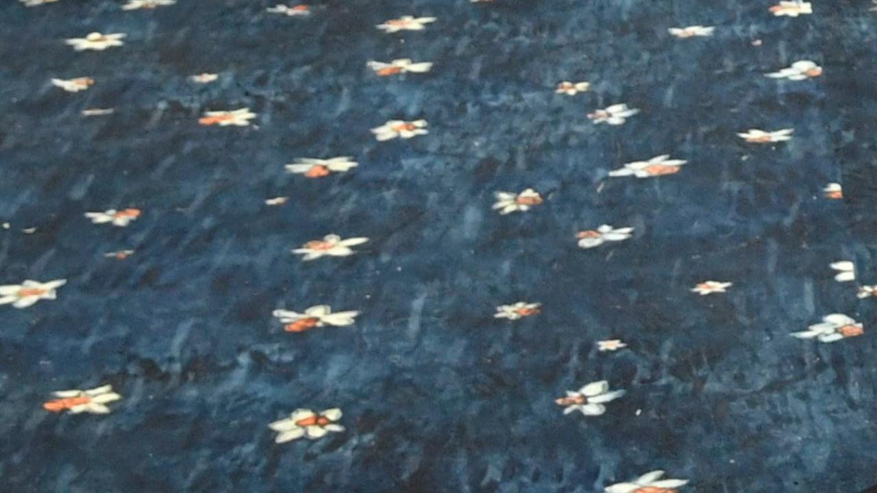 The 63,000-square-foot blue carpet was accented by strewn daffodils, cascading floral barricades, and installations that shimmered with water and mirrored the hanging blooms above