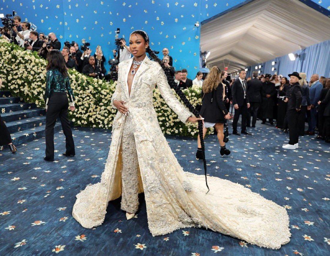 Meanwhile, Jones made a striking statement in a floral-inspired ensemble by Indian designer Manish Malhotra, featuring intricate beadwork in silver, white, and cream. The look included a dramatic long-sleeve coat with sharp lapels and a cinched waist, paired with coordinated trousers