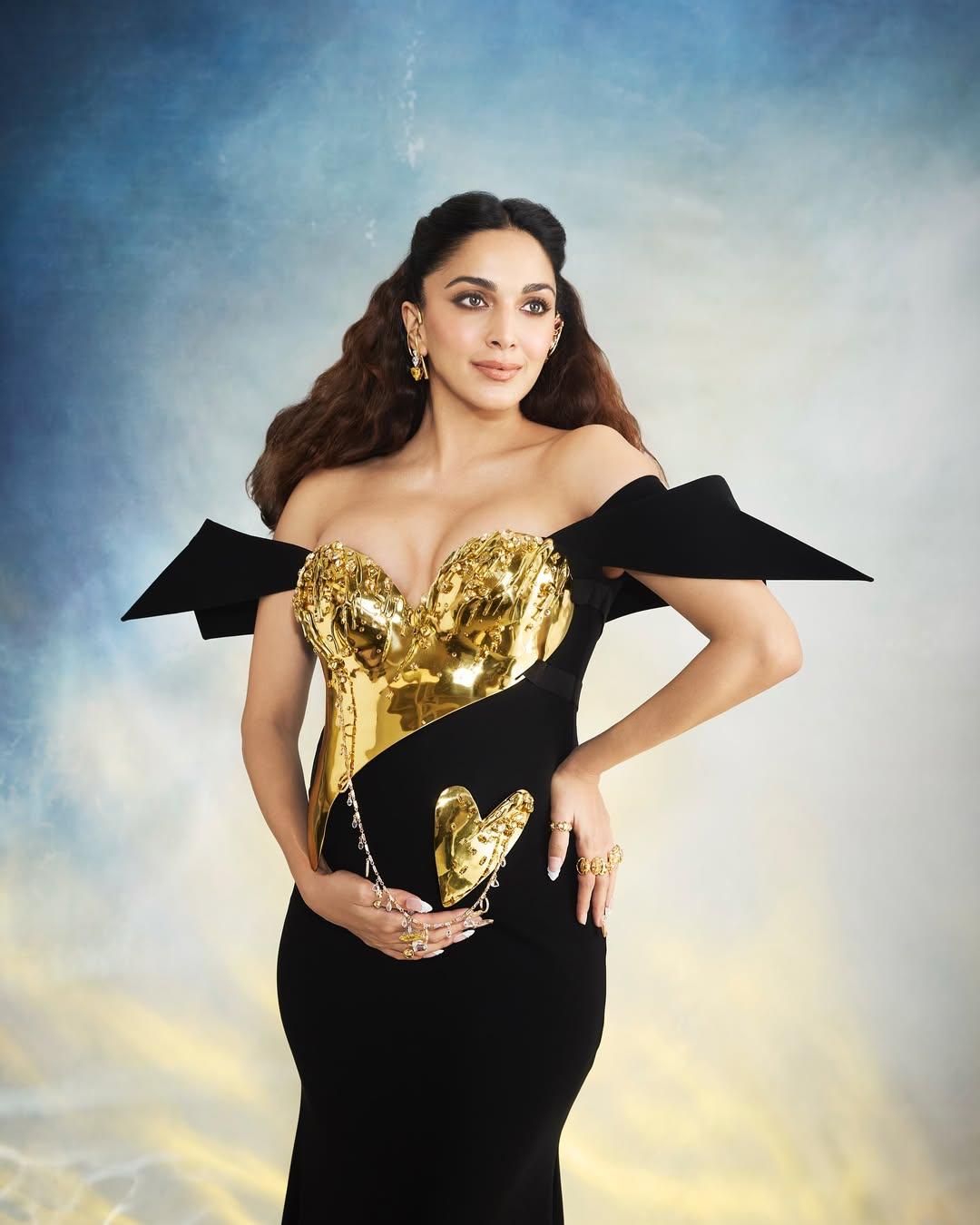 Draped in a custom couture creation by renowned Indian designer Gaurav Gupta, Kiara’s look celebrated both her cultural roots and her personal evolution. Her ensemble, titled Bravehearts, included sculptural precision. The gown featured an antique gold breastplate adorned with ghungroos and crystals. Two symbolic forms—Mother Heart and Baby Heart—were linked by a chain umbilical cord, visually narrating the bond of motherhood