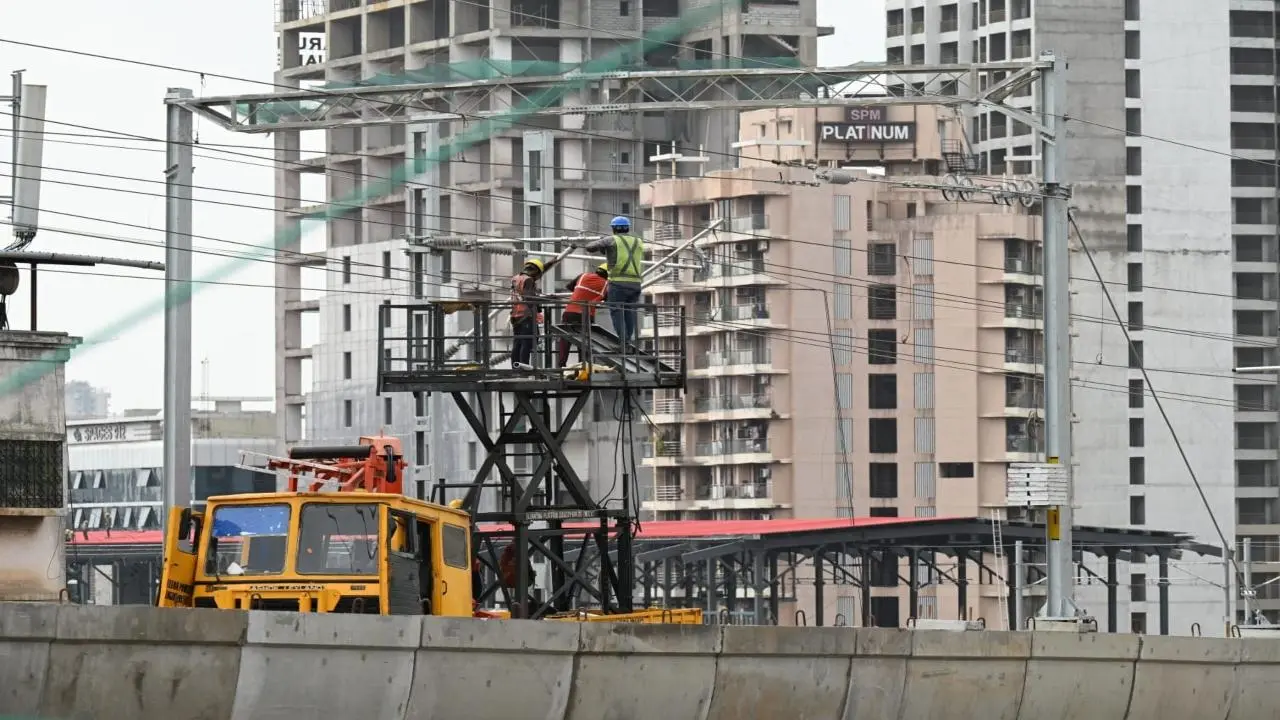 Workers install overhead equipment for Mumbai Metro-9 in Mira Road; check photos