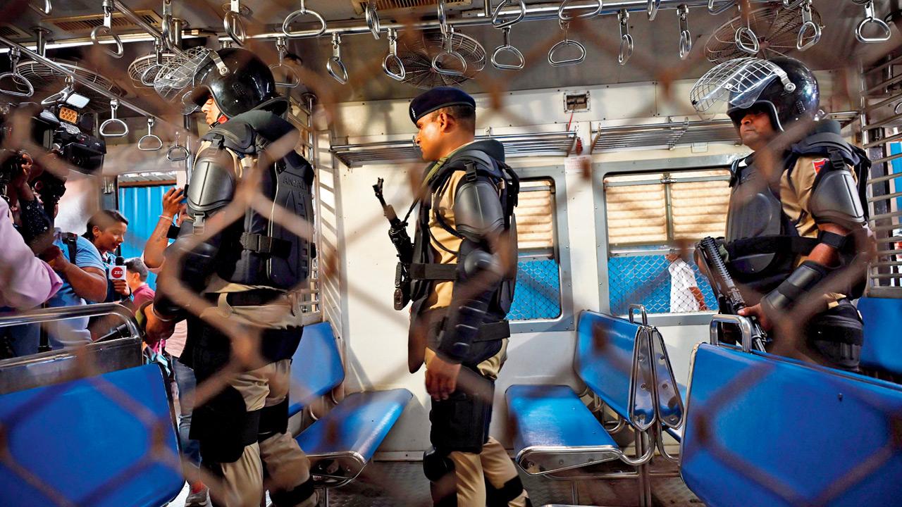 Security personnel board a train at CSMT