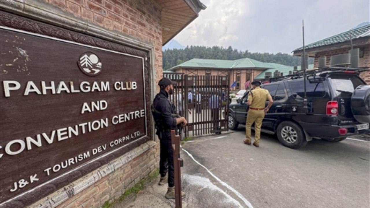 Security personnel stand guard as Jammu and Kashmir Chief Minister Omar Abdullah arrives at the Pahalgam Club and Convention Centre